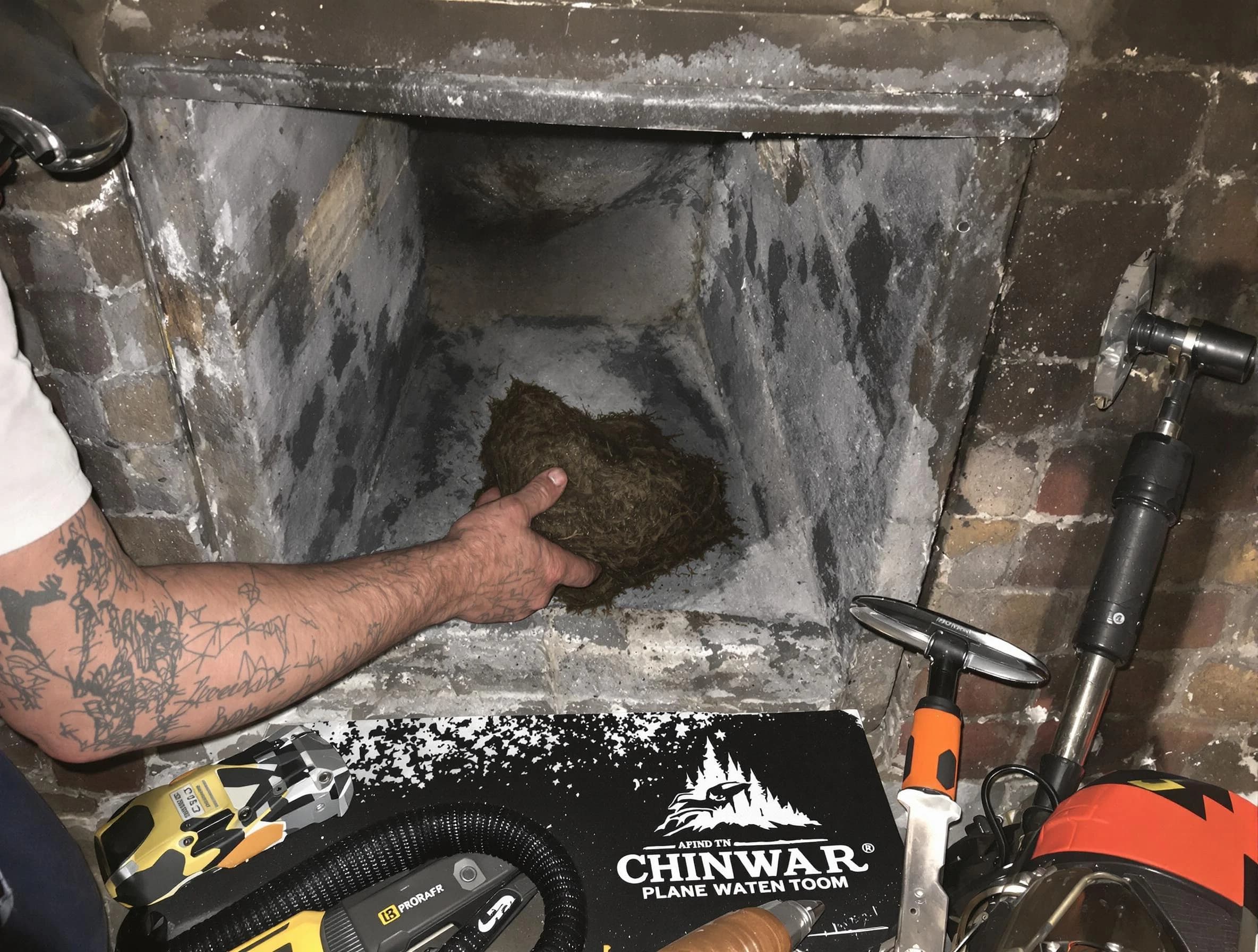 South Ogden Chimney Sweep safely removing debris and screening chimney in South Ogden, UT